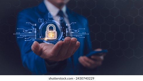 A businessman in a blue suit interacts with a futuristic holographic security interface, featuring a glowing padlock symbol, signifying advanced digital protection. Secure business networks