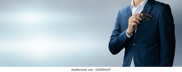 Businessman in blue suit put or take out credit card in pocket with copy space background, Technology digital future of business finance and payment online shopping concept, Handsome young in close up - Powered by Shutterstock