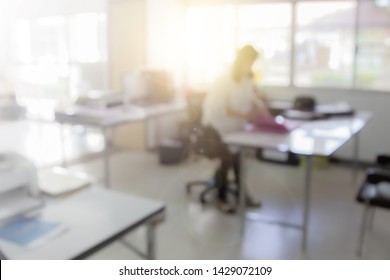 Businessman Blur In The Workplace At Sitting On A Computer Screen Work Space Of Table Work In Office With Fax, Document Division And Printer Or Shallow Depth Of Focus Horizontal Abstract Background.