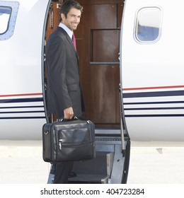 A Businessman Boarding A Plane