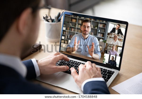 Businessman boss leader leads distant\
communication diverse businesspeople involved in group videocall\
conversation discuss common project, partners negotiating. Modern\
technology and business\
concept