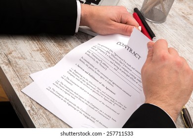 Businessman breaking a Contract at the office 