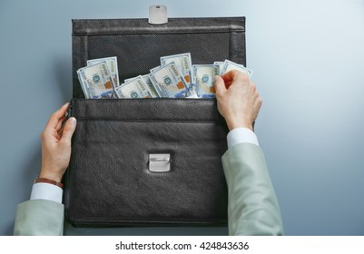 Businessman And Brief Case With Money