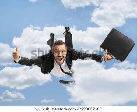 Businessman with a briefcase flying and gesturing thumbs up up in the sky 