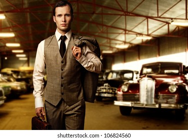 Businessman With A Briefcase In Garage