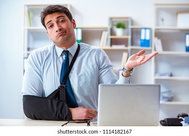 Businessman With Broken Arm Working In Office