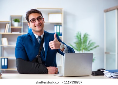 Businessman With Broken Arm Working In Office