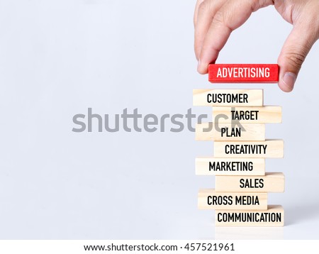 Businessman Building ADVERTISING Concept with Wooden Blocks