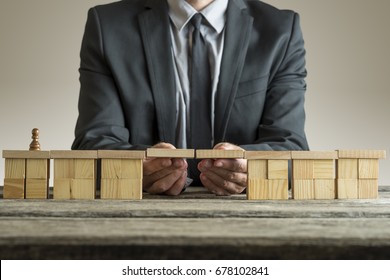 Businessman Building Bridge With Wooden Block To Span A Gap For Chess Piece Pawn, Conceptual Image.
