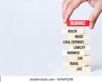 Businessman Building INSURANCE Concept With Wooden Blocks