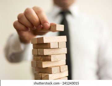 businessman builds a tower - Shutterstock ID 241243015