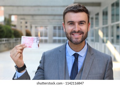 Businessman Burning Twenty Pound Note