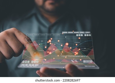 Businessman business analyzing the ongoing of the graph, data stock market, profit on a modern interface, financial investment concept. A rapidly changing business - Shutterstock ID 2208282697
