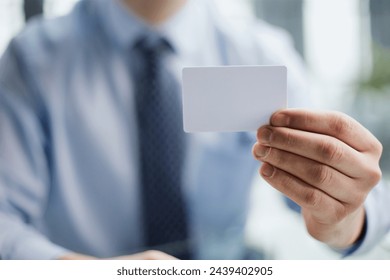 Businessman ,Business Man's hand hold showing business card - close up shot. - Powered by Shutterstock