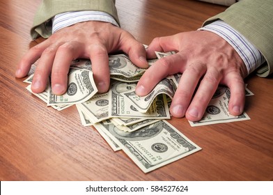 businessman in business suit takes money (dollars)