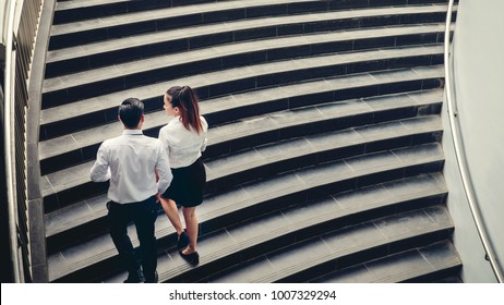 Businessman And Business Woman Go Up The Stairs Success Concept