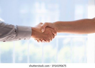 Businessman and business woman shaking hands