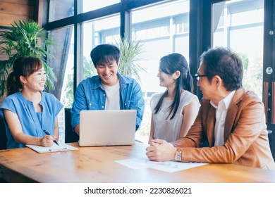 Businessman and businesswoman in casual clothes having a meeting - Shutterstock ID 2230826021