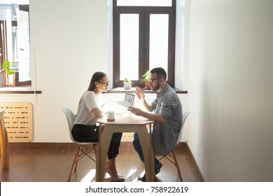 Businessman And Businesswoman Discussing Working Problems In Office. Two Millennial Employees Having Business Meeting And Arguing Job Questions