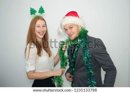 businessman and businesswoman dressed in Christmas costumes at the Christmas party