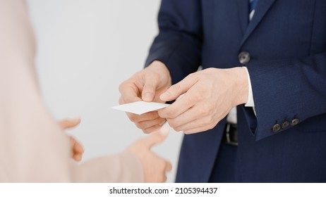 Businessman and businesswoman exchanging business cards. - Powered by Shutterstock