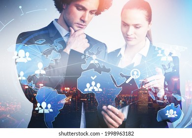 Businessman And Businesswoman Are Looking For New Talented Candidates For Corporate Company. Hologram World Map With Alumni Network. Concept Of Recruitment Process. Night Singapore City View