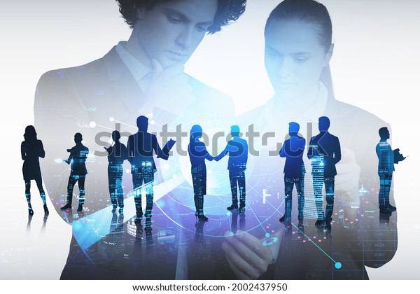 Businessman and businesswoman are looking for new\
talented candidates for corporate company. Hologram digital\
interface with alumni network. Concept of recruitment process.\
Night Singapore city\
view