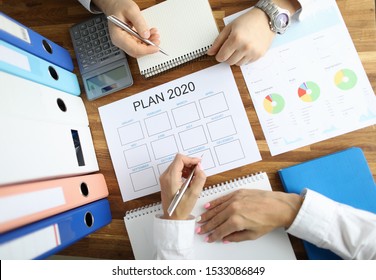 Businessman And Businesswoman Make Work Plan 2020 On Office Table With Folder Paper Background. Business Paperwork Concept