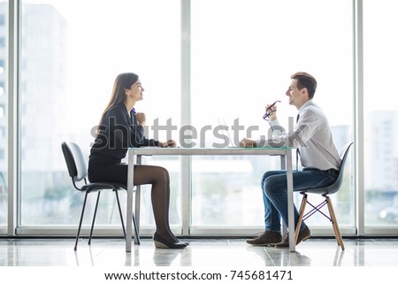 Businessman And Businesswoman Meeting In Modern Office