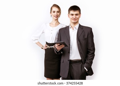 Businessman and businesswoman stands on white backdrop 