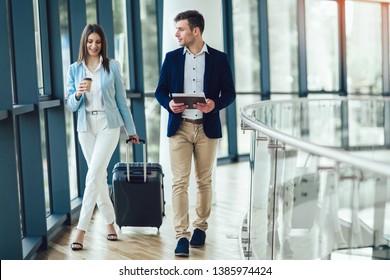 Businessman And Businesswoman Talking And Hold Luggage Travel To Business Trip.