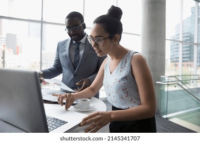 Businessman and businesswoman working at laptop - Shutterstock ID 2145341707