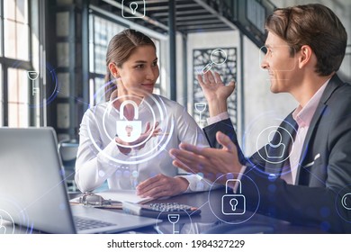 Businessman and businesswoman working together to protect clients confidential information and cyber security. IT hologram padlock icons over office background with panoramic windows. - Powered by Shutterstock