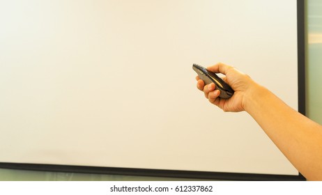 Businessman Or Businesswomen Make A Presentation Using Laser Pointer, Point On The Projector, Board