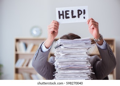 Businessman busy with paperwork in office - Shutterstock ID 598270040