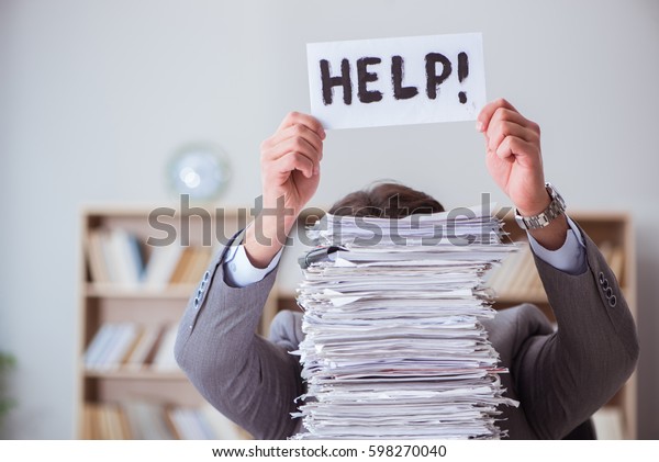 Businessman busy with\
paperwork in office