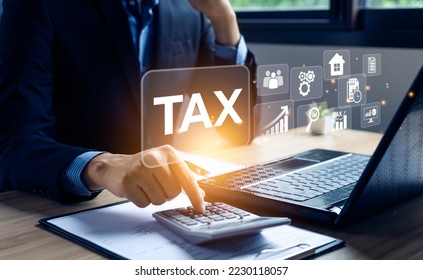Businessman calculating annual taxes and paying taxes. Tax deduction planning concept. Expenses, account, VAT, income tax, Calculation of taxes, expenses, exemptions, deductions, donations