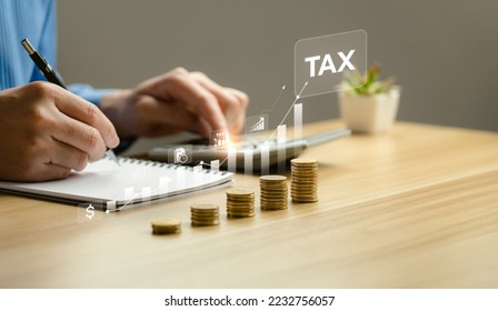 Businessman calculating annual taxes and paying taxes. Tax deduction planning concept. Expenses, account, VAT, income tax, Calculation of taxes, expenses, exemptions, deductions, donations - Shutterstock ID 2232756057