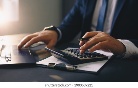 Businessman Calculating The Financial Statement Of His Business. Accounting And Tax.