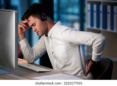 Businessman, Call Center And Back Pain From Burnout, Headache Or Overworked Late At Night By The Office Desk. Man Consultant Suffering In Pain, Sore Back Or Discomfort From Long Hours On The Computer