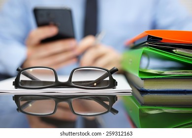 Businessman Is Calling Financial Adviser For Help.Focus On Glasses