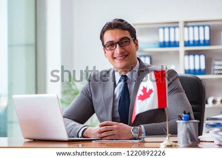Businessman with Canadian flag in office