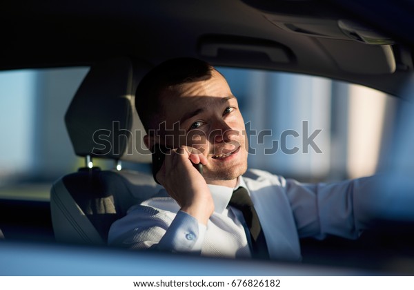 businessman in car with phone\
