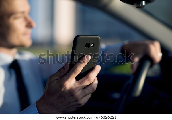 businessman in car with phone\
