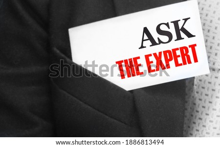 Businessman with a card with text Ask the Expert in upper suit pocket. Business concept.