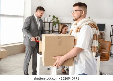 Businessman carrying box in office on moving day - Powered by Shutterstock