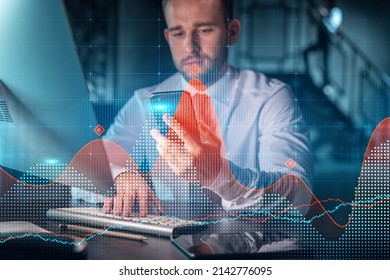 Businessman In Casual Wear Using Smart Phone To Optimize Trading Strategy At Corporate Finance Fund. Forex Chart Hologram Over Modern Office Background At Night Time