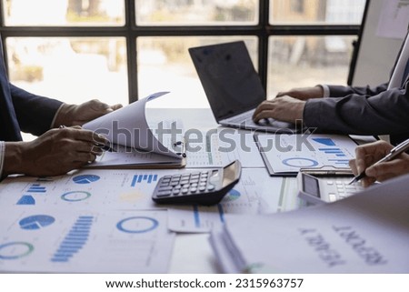 Businessman and Certified Public Accountant Accounting services and auditing on company charts and stock market data at teamwork concept meetings.