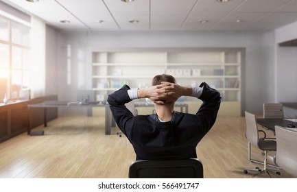 Businessman in chair having rest . Mixed media - Shutterstock ID 566491747
