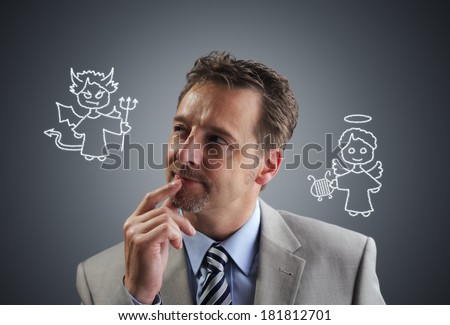 Businessman with chalk drawing angel and devil on his shoulders concept for conscience, decisions, uncertainty or moral dilemma